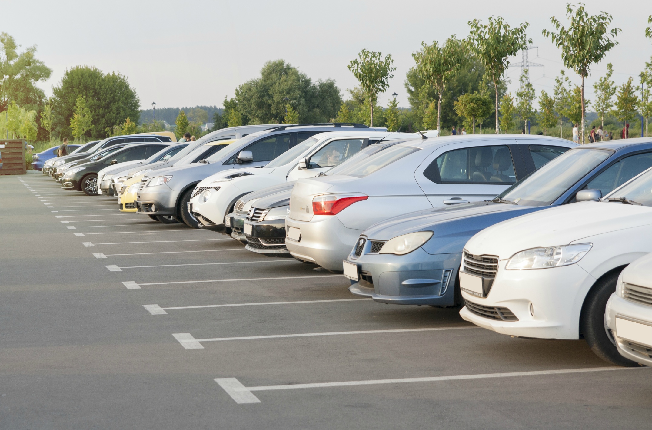 cars-parking-lot-evening-light-sun